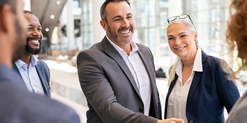 business man shaking hands with another person out of frame