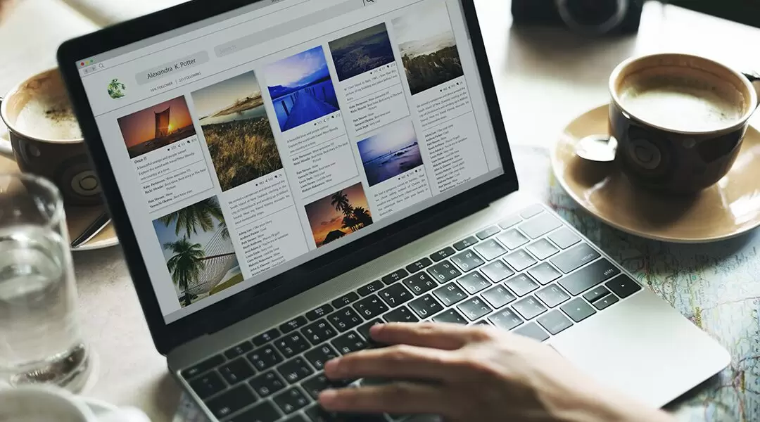 person scrolling through blog on laptop