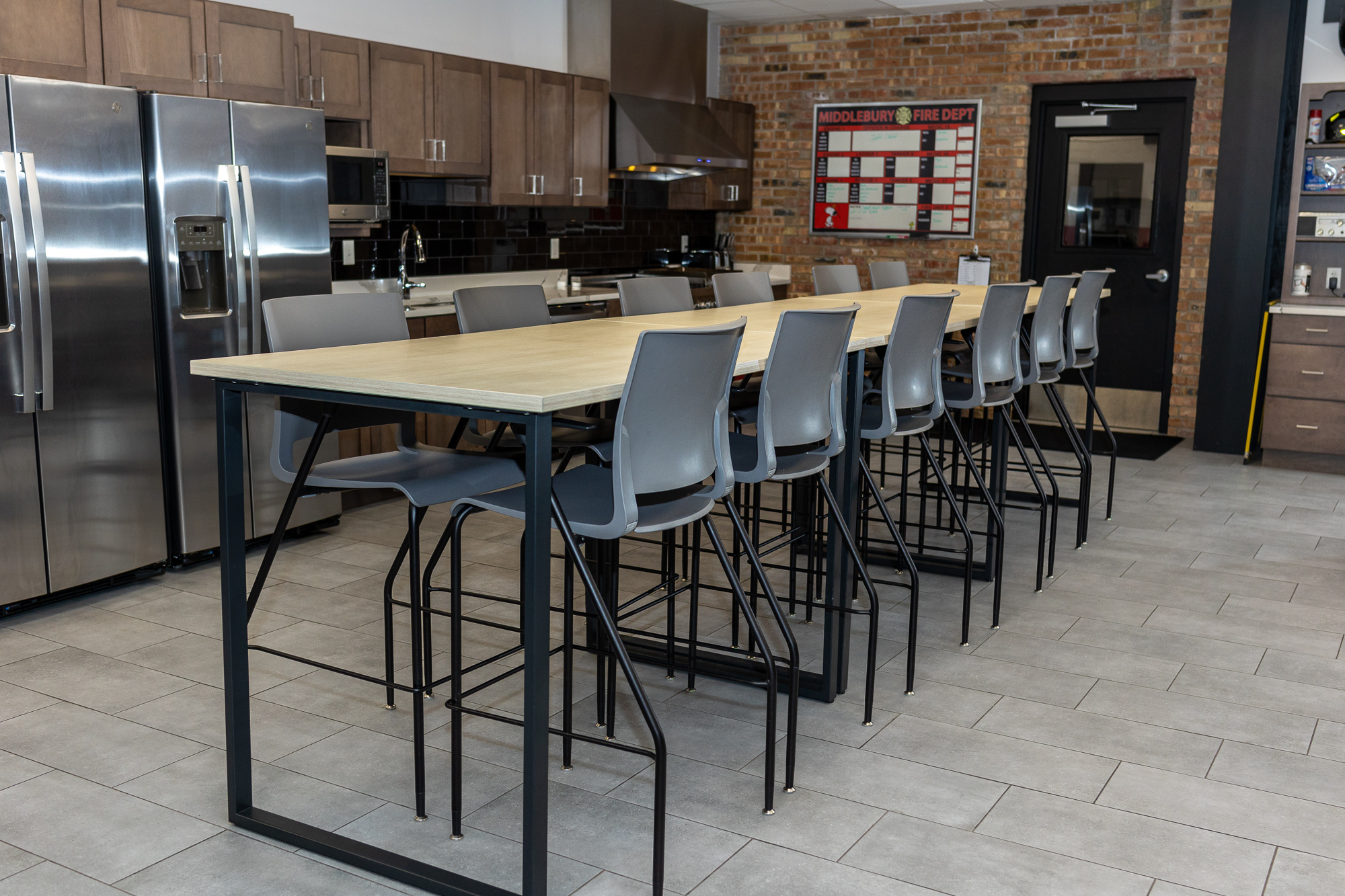 long table with chairs in kitchen eating area