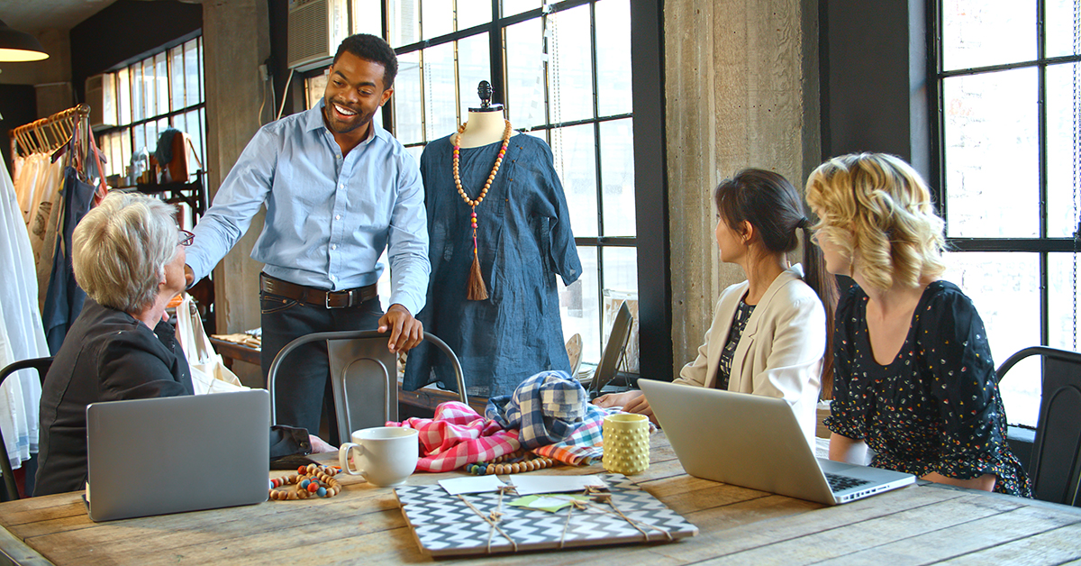 Male And Female Fashion Designers In Studio Meeting Discussing G • Sharp Wilkinson Male And Female Fashion Designers In Studio Meeting Discussing Garments
