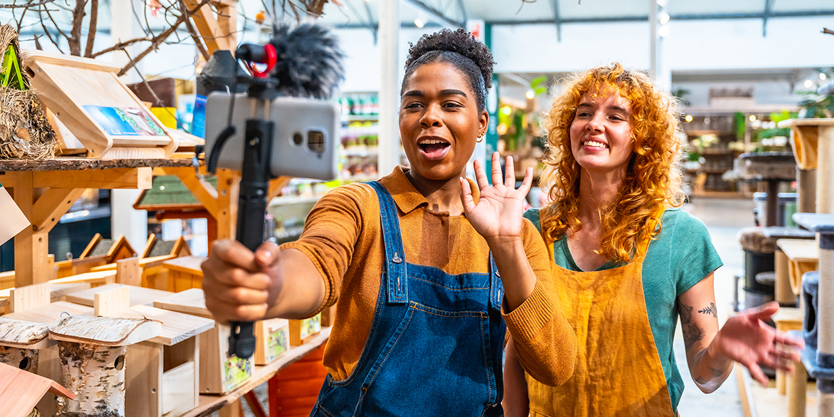 Two saleswomen filming a video for social media marketing in a pet shop • Sharp Wilkinson Two saleswomen filming a video for social media marketing in a pet shop