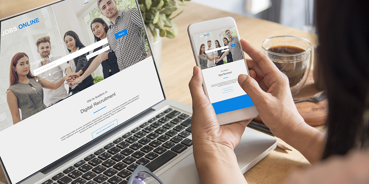 woman looking at website on both phone and laptop