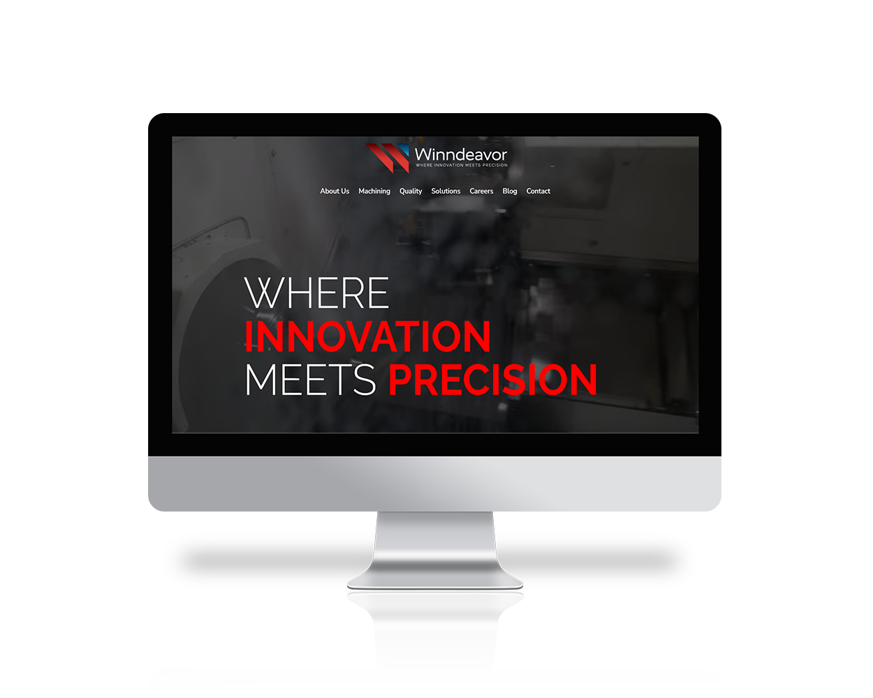 Monitor shows a dark hero image with the company logo and navigation, featuring the slogan 'WHERE INNOVATION MEETS PRECISION' in white and red.